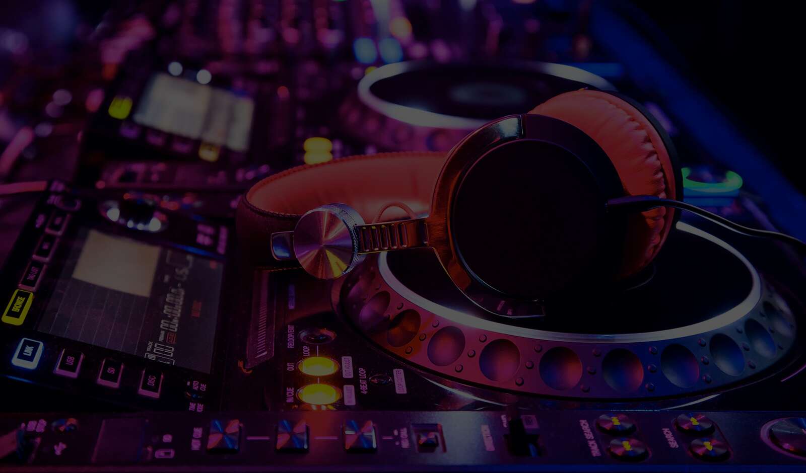 Pair of headphones sitting on some CDJs