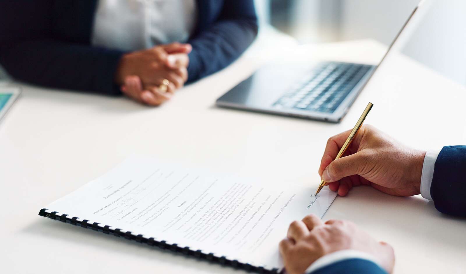 Someone signing a contract