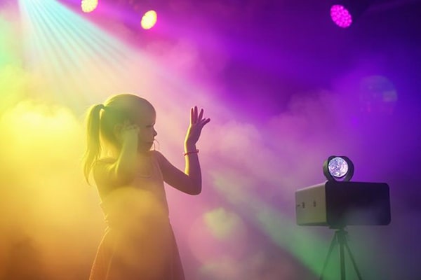 Little girl in the fog at a kids disco